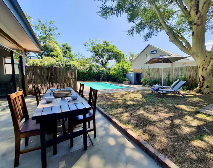 Outdoor dining beside the private pool and garden