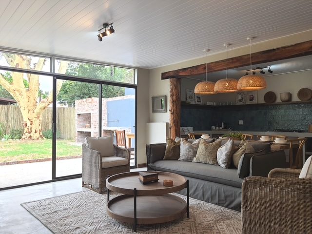 Open plan living, looking through to the kitchen and out to the braai