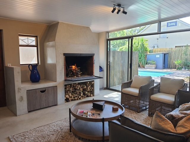 Wood fire lit in the lounge, with the pool through the sliding doors